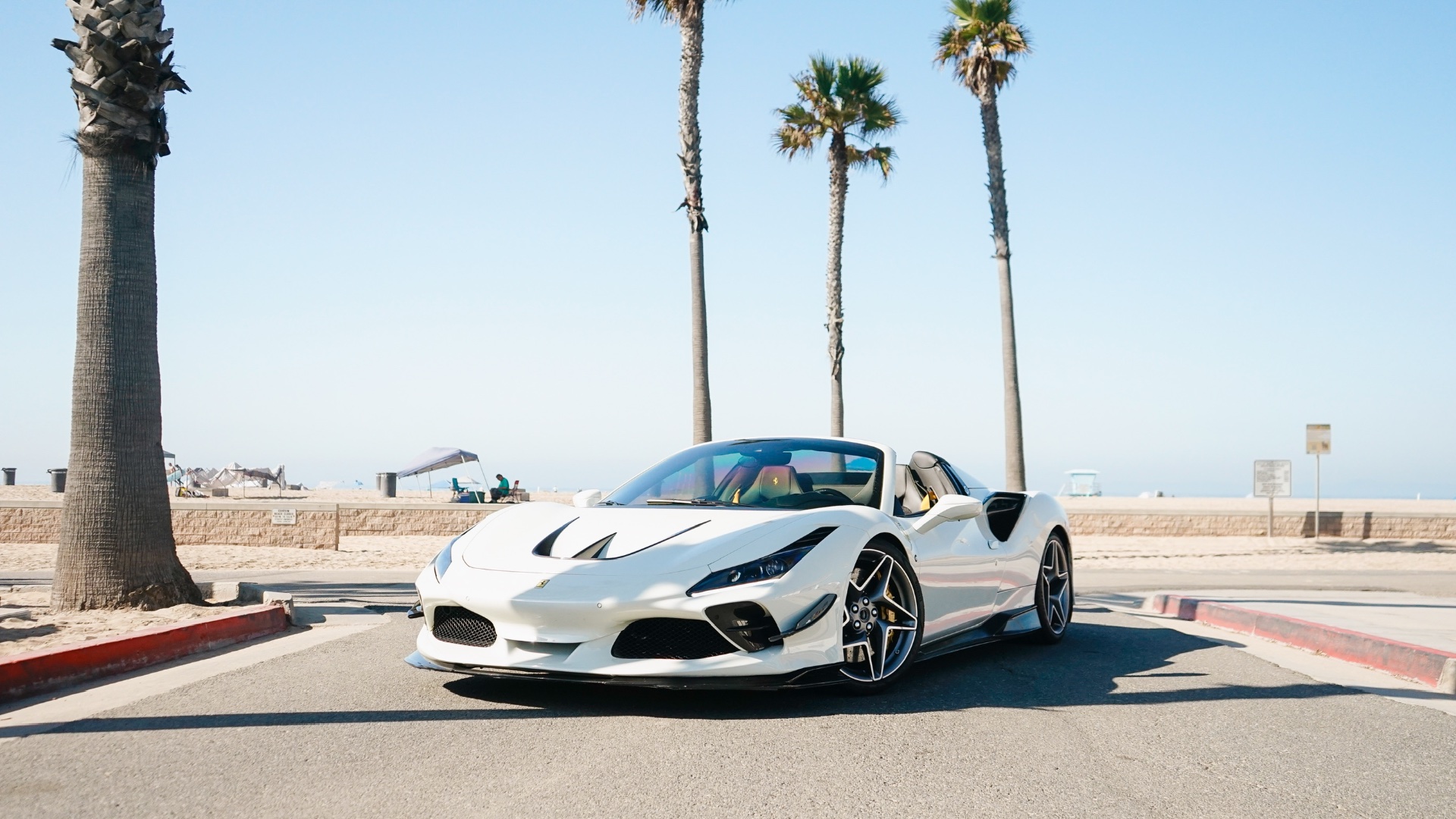 White Ferrari F8 Spyder on Pacific Coast Highway Malibu at golden hour